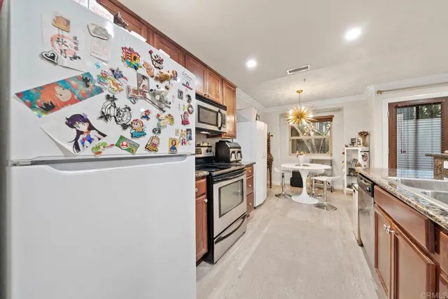 a kitchen with stainless steel appliances a refrigerator and a sink
