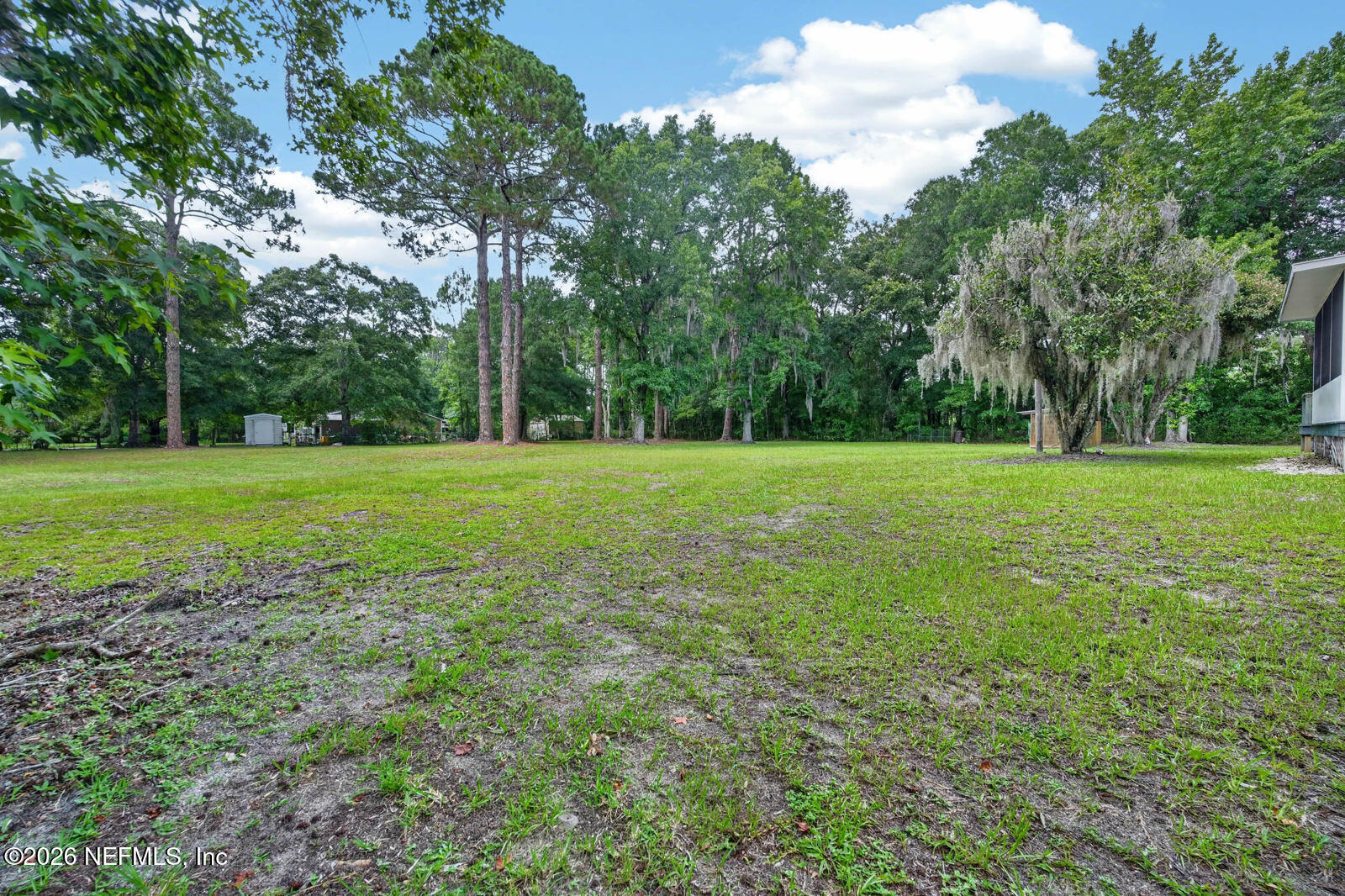 1950 Lightsey Road St. Augustine, FL 32084 - Photo 38 of 57 a view of a grassy field with trees in the background