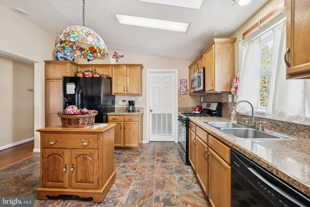 a kitchen with sink stove and cabinets
