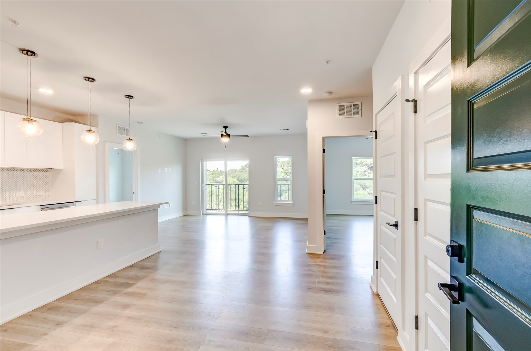 2500 Longview Street, Unit 402 Austin, TX 78705 - Photo 1 of 27 a open kitchen with white cabinets and stainless steel appliances