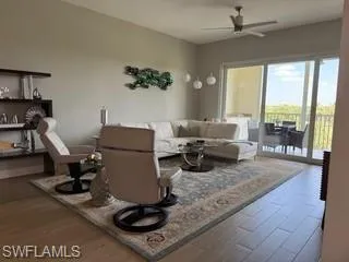 a living room with furniture and a floor to ceiling window