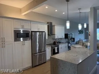 a kitchen with refrigerator a sink and a counter top space