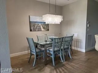 a view of a dining room with furniture wooden floor and chandelier