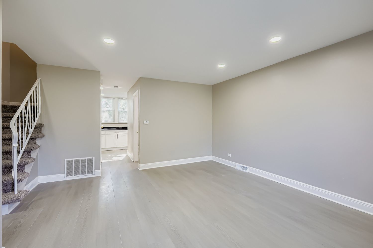 2131 Ash Street, Unit G Des Plaines, IL 60018 - Photo 3 of 16 a view of an empty room with wooden floor and staircase