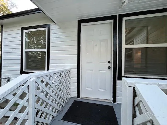 a view of a backyard with table and chairs and wooden fence