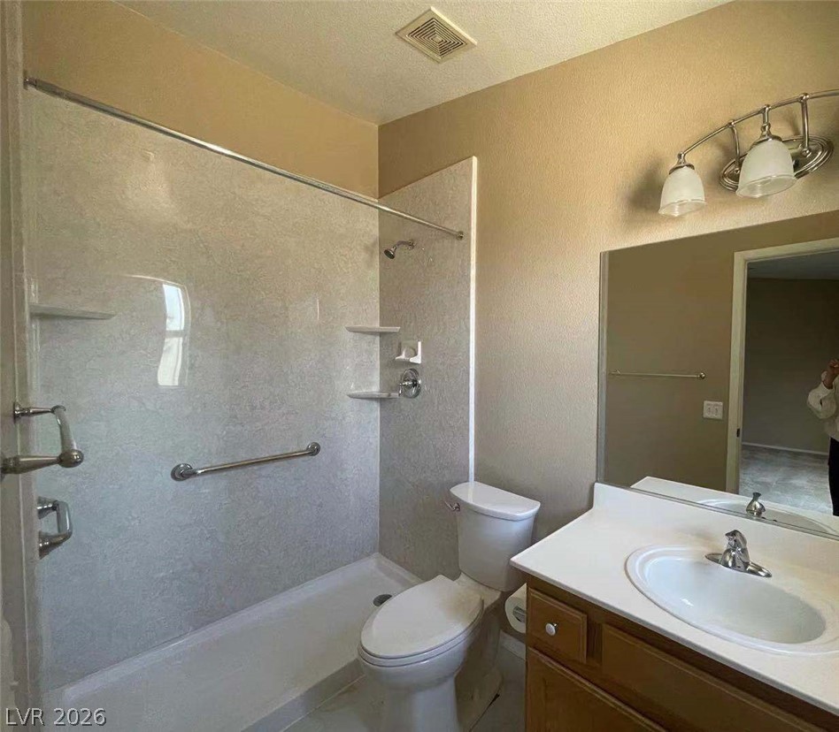 3500 Redwood Ridge Way North Las Vegas, NV 89031 - Photo 8 of 13 A compact and functional bathroom offering a shower, toilet, and vanity with ample counter space.