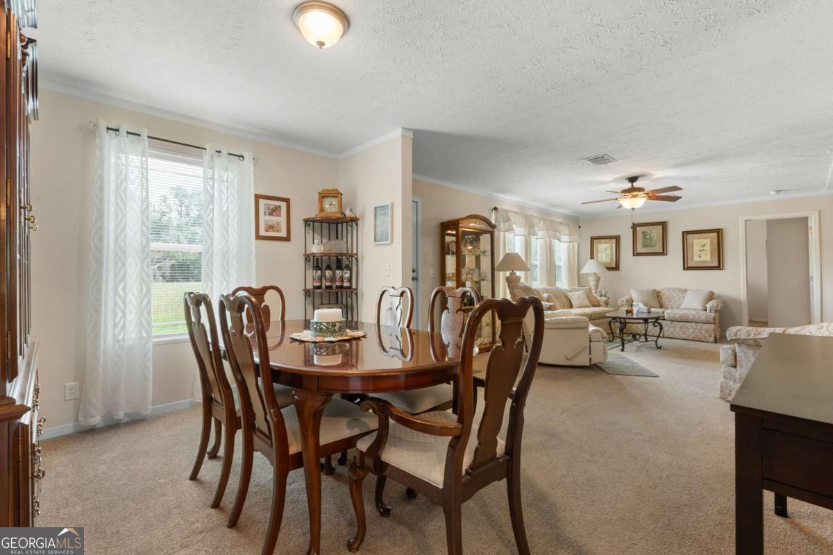 3516 Bennetts Landing Road Millen, GA 30442 - Photo 14 of 34 a view of a dining room with furniture and a window