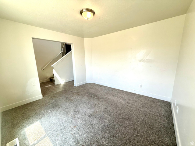 1823 South Longview Road Santaquin, UT 84655 - Photo 10 of 69 Spacious room featuring neutral carpeting, light-toned walls, and a ceiling-mounted light fixture