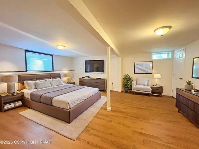 a spacious bedroom with a large bed and a view of bedroom