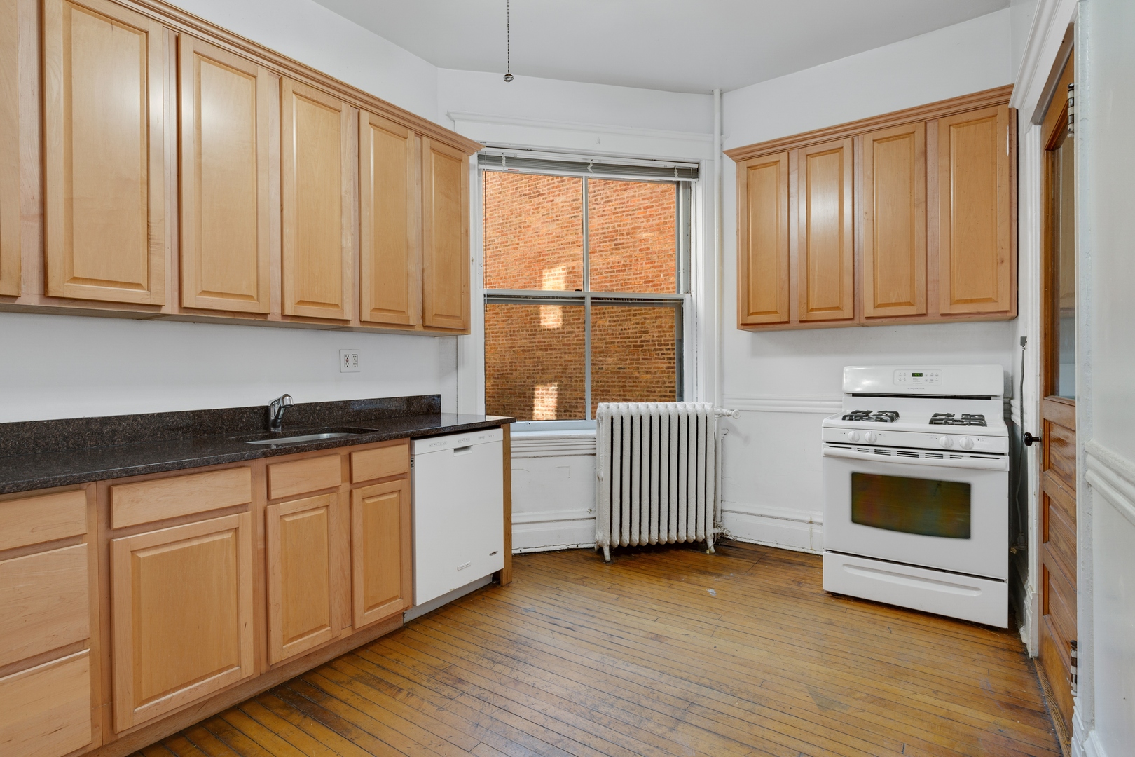 2113 West Concord Place Chicago, IL 60647 - Photo 11 of 20 a kitchen with granite countertop wooden cabinets a sink and a stove