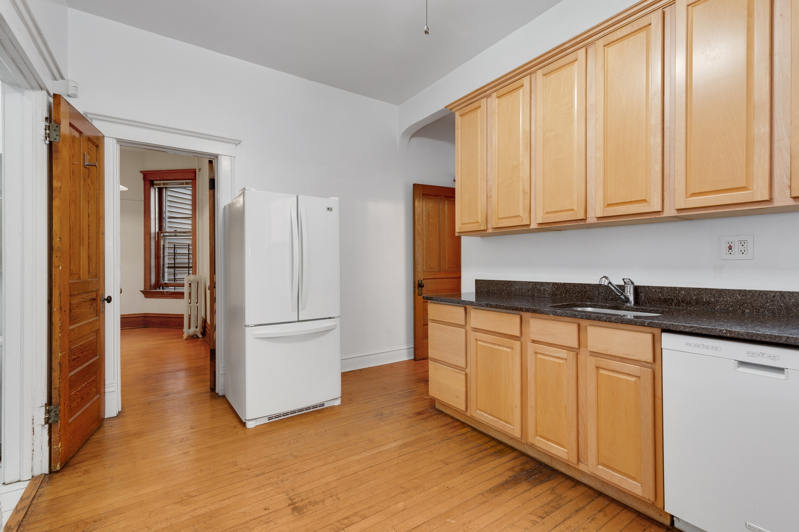 2113 West Concord Place Chicago, IL 60647 - Photo 12 of 20 a kitchen with stainless steel appliances granite countertop a refrigerator sink and cabinets