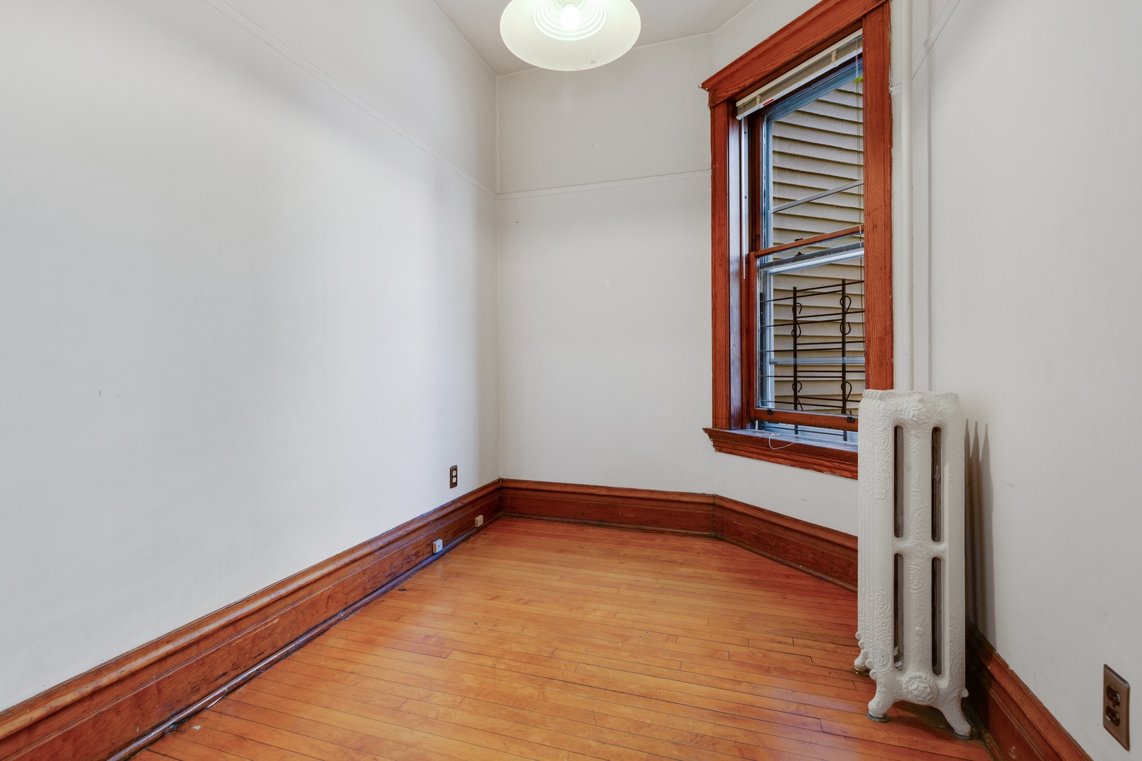 2113 West Concord Place Chicago, IL 60647 - Photo 13 of 20 a view of an empty room with wooden floor and a window