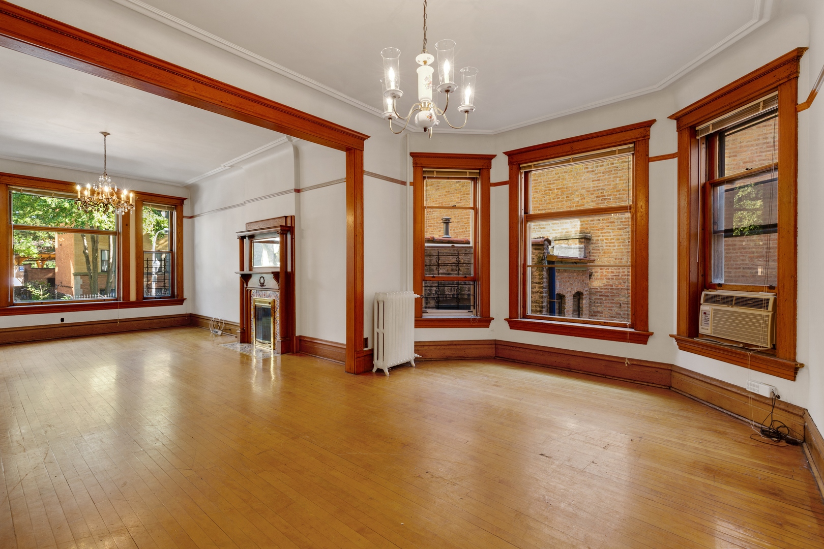 2113 West Concord Place Chicago, IL 60647 - Photo 5 of 20 a view of an empty room with a window and wooden floor