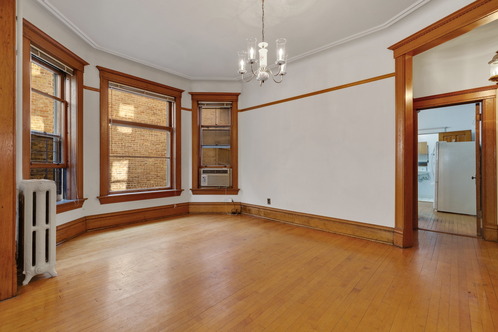 2113 West Concord Place Chicago, IL 60647 - Photo 6 of 20 a view of an empty room with window and chandelier fan