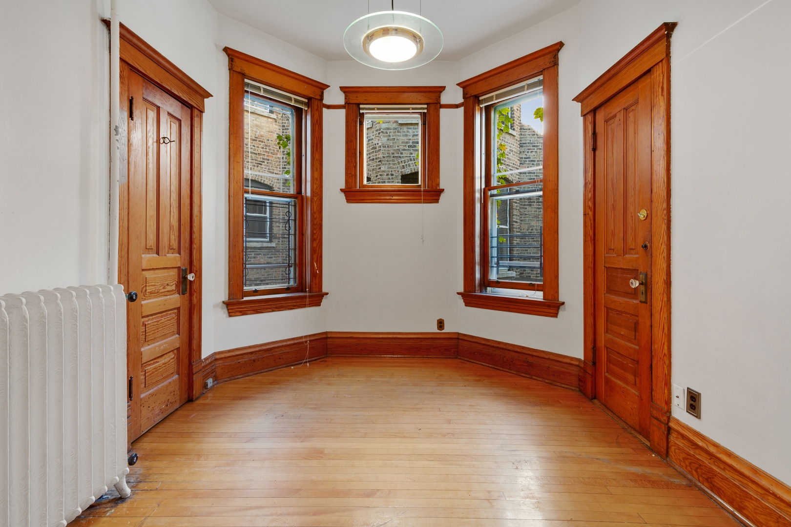 2113 West Concord Place Chicago, IL 60647 - Photo 7 of 20 an empty room with wooden floor and windows