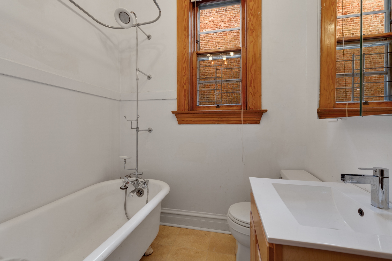 2113 West Concord Place Chicago, IL 60647 - Photo 9 of 20 a bathroom with a tub a sink and a window