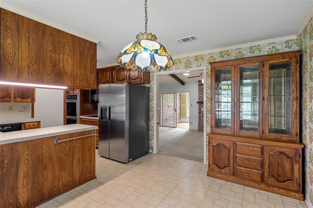 219 Opal Street Hewitt, TX 76643 - Photo 7 of 28 a kitchen with stainless steel appliances granite countertop a refrigerator a sink and dishwasher