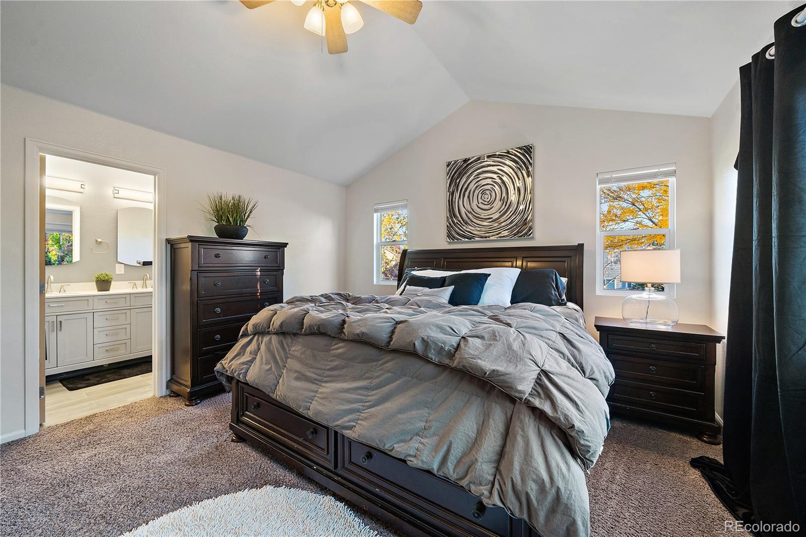 11312 Jersey Drive Thornton, CO 80233 - Photo 11 of 19 a bedroom with a bed and a chandelier