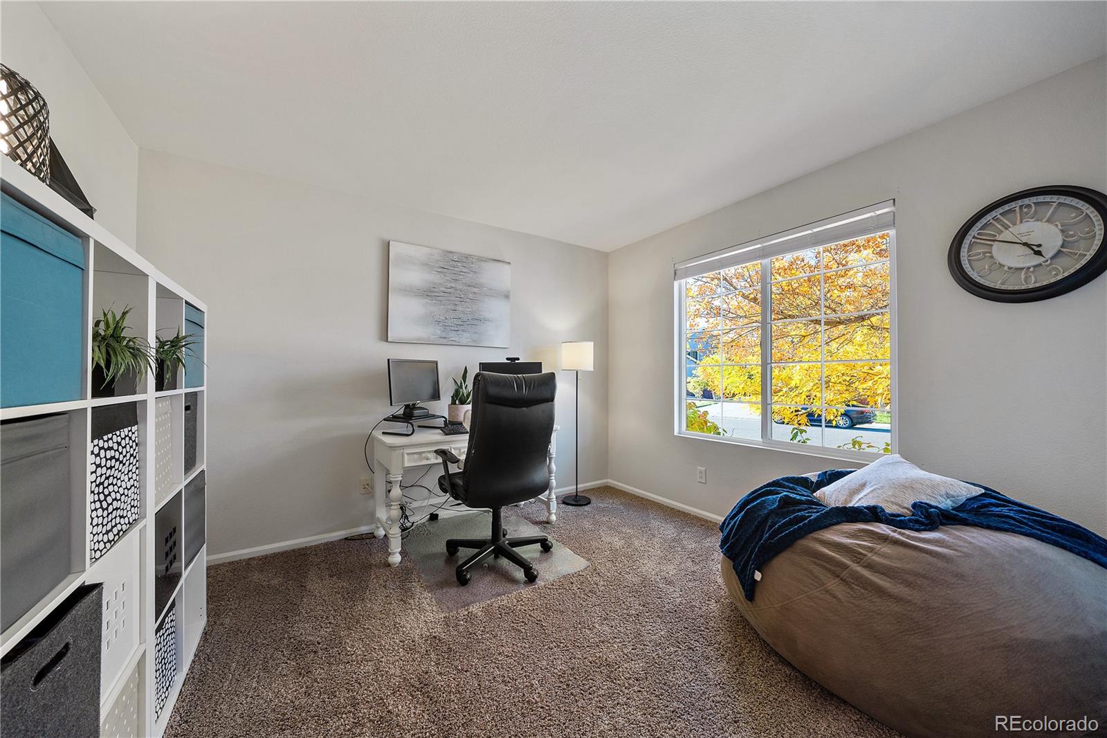 11312 Jersey Drive Thornton, CO 80233 - Photo 15 of 19 a bedroom with a bed and a window