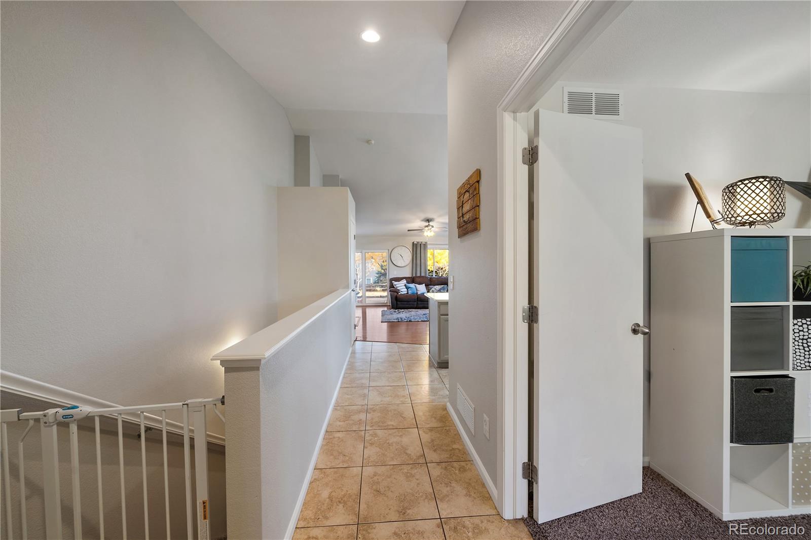 11312 Jersey Drive Thornton, CO 80233 - Photo 2 of 19 a view of a hallway with wooden floor and staircase