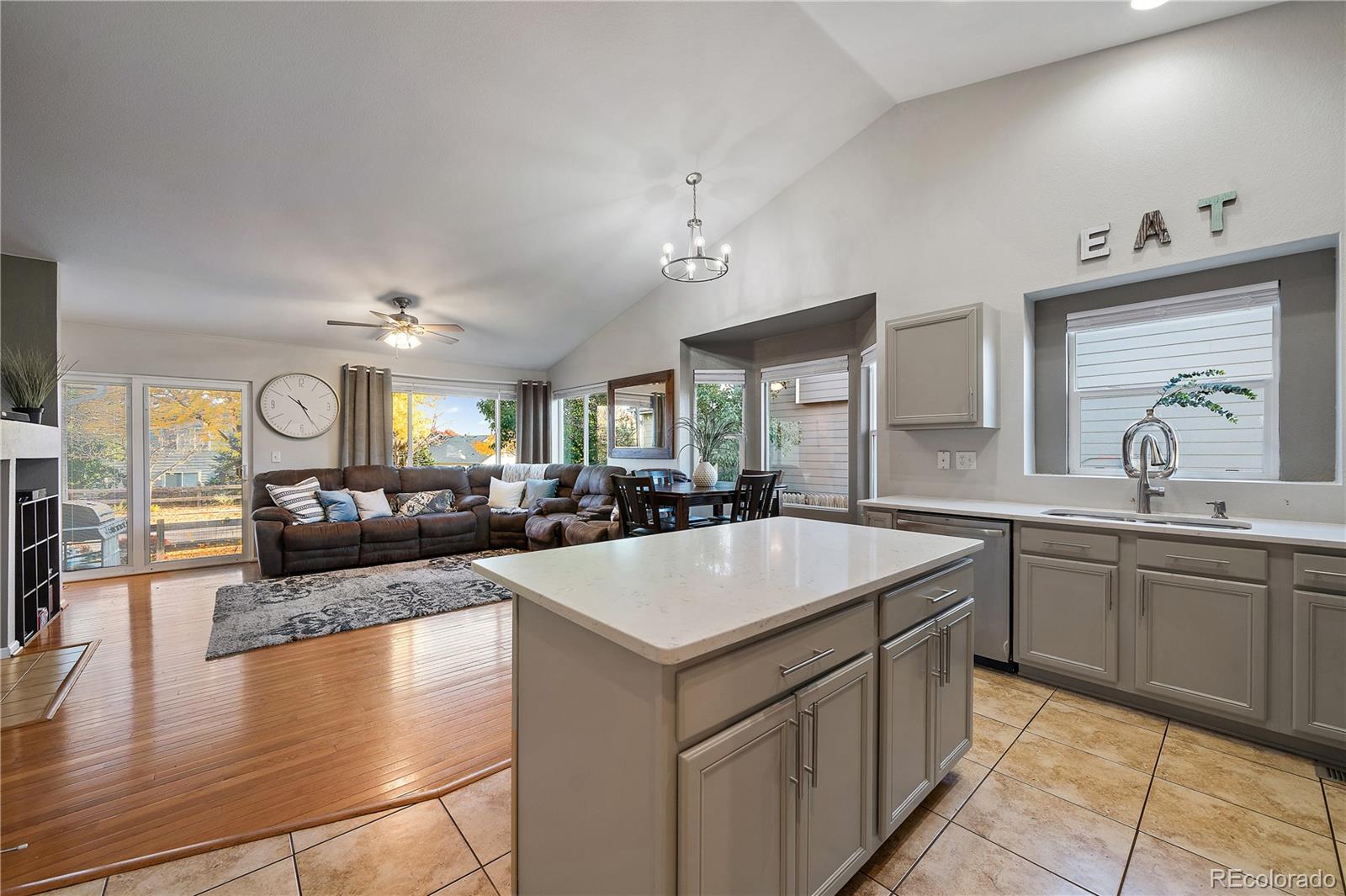 11312 Jersey Drive Thornton, CO 80233 - Photo 3 of 19 a large kitchen with kitchen island a sink table and chairs