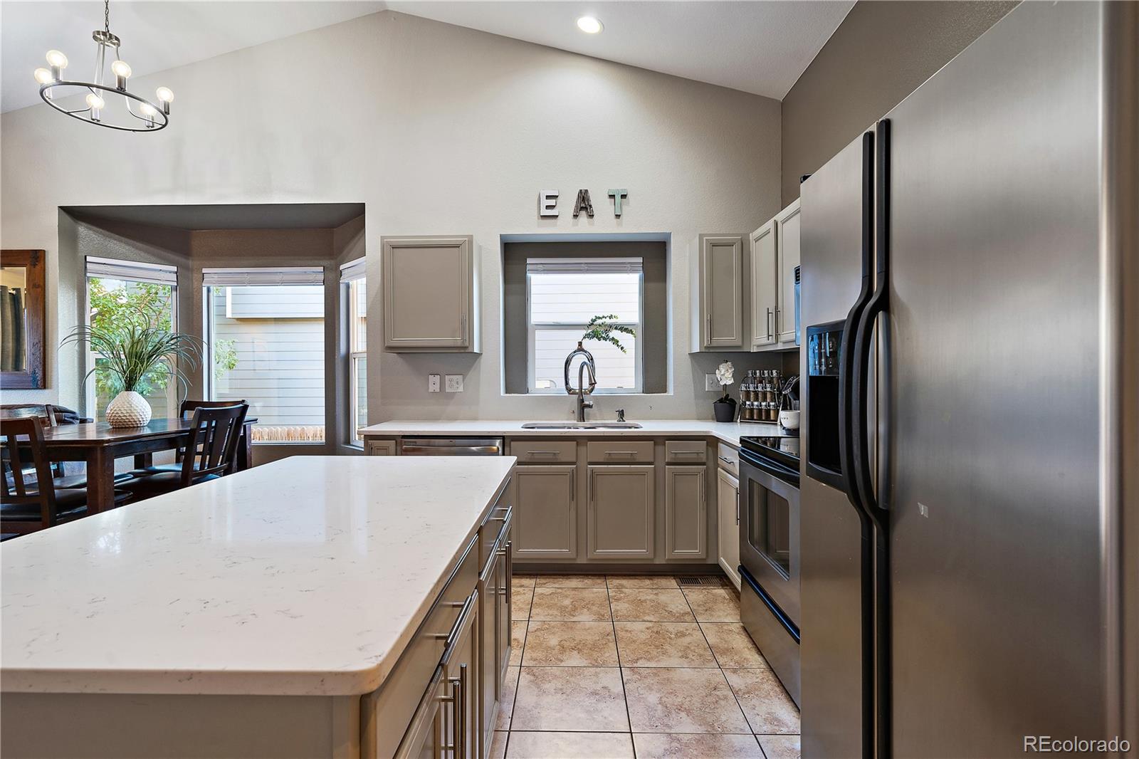 11312 Jersey Drive Thornton, CO 80233 - Photo 8 of 19 a kitchen with stainless steel appliances granite countertop a sink refrigerator and window
