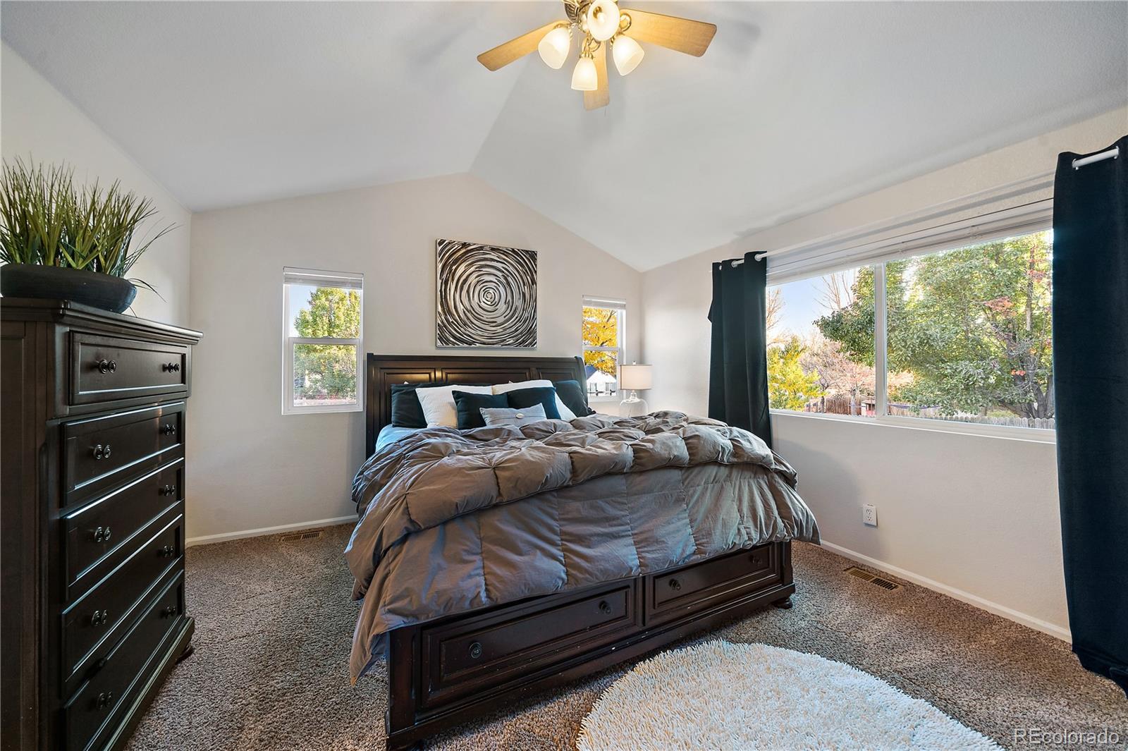11312 Jersey Drive Thornton, CO 80233 - Photo 10 of 19 a bedroom with a bed and a flat screen tv