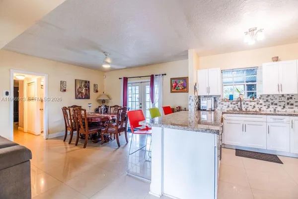 a living room with furniture a dining table and kitchen view