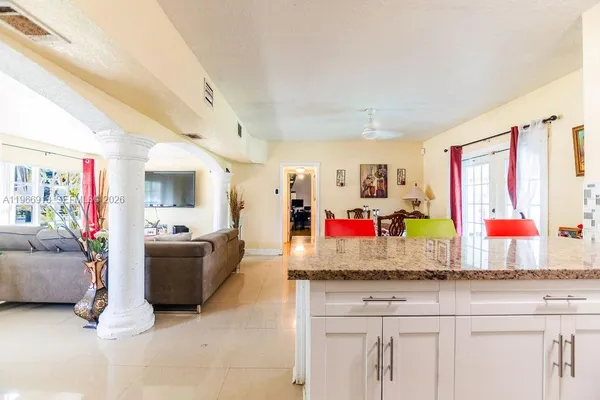 a living room with granite countertop furniture and flat screen tv
