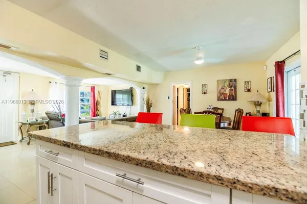 a kitchen with stainless steel appliances granite countertop a sink refrigerator and microwave