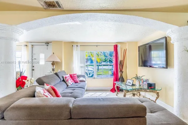 a living room with furniture and a flat screen tv