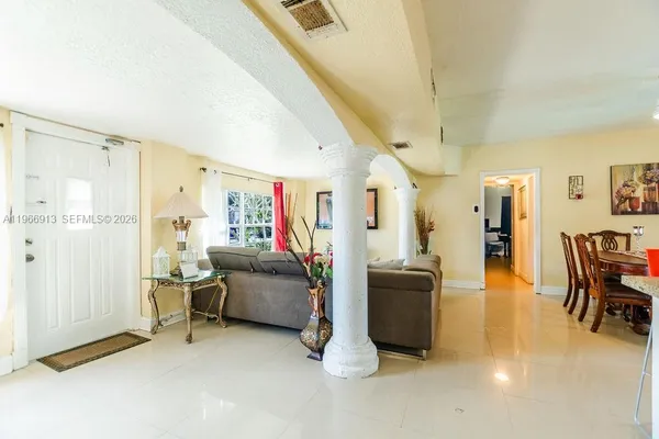 a view of a livingroom with furniture and a flat screen tv