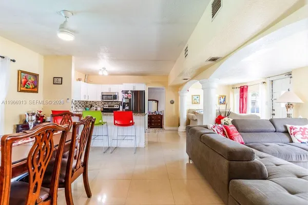 a living room with furniture and kitchen view
