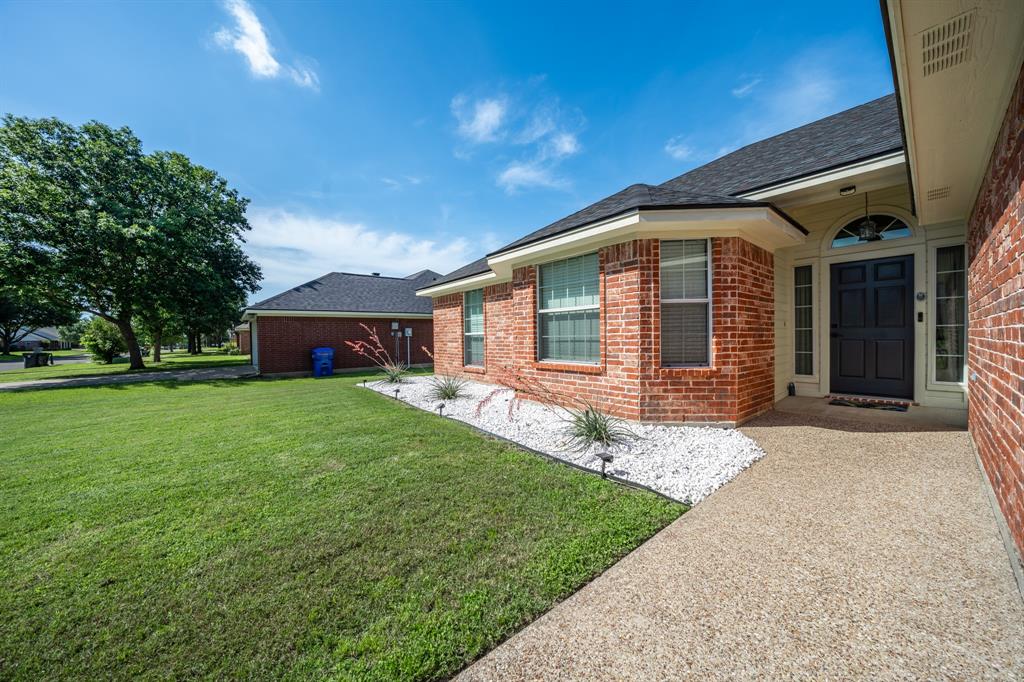 10512 Whitney Trace Drive Waco, TX 76708 - Photo 2 of 39 Brick exterior with a dark entry door and arched transom window