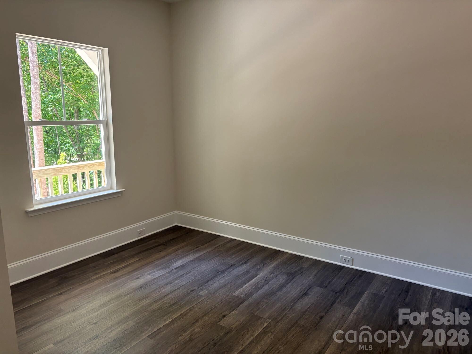 250 Ashley Acres Road Statesville, NC 28677 - Photo 11 of 21 a view of an empty room with wooden floor and a window
