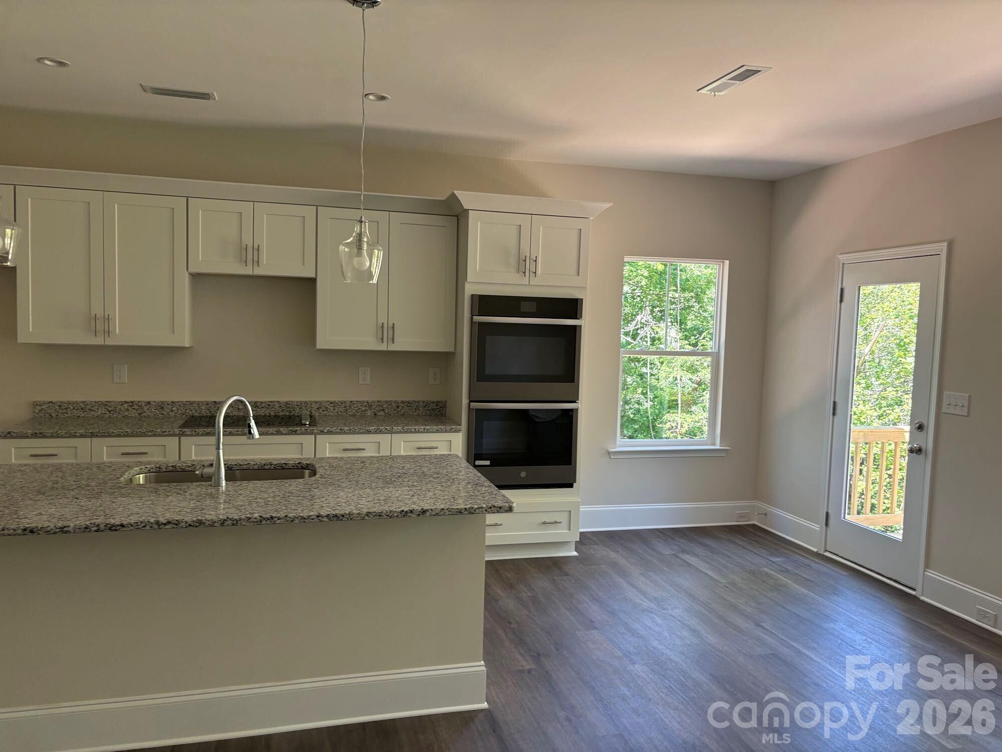 250 Ashley Acres Road Statesville, NC 28677 - Photo 8 of 21 a kitchen with granite countertop a stove a sink and a microwave