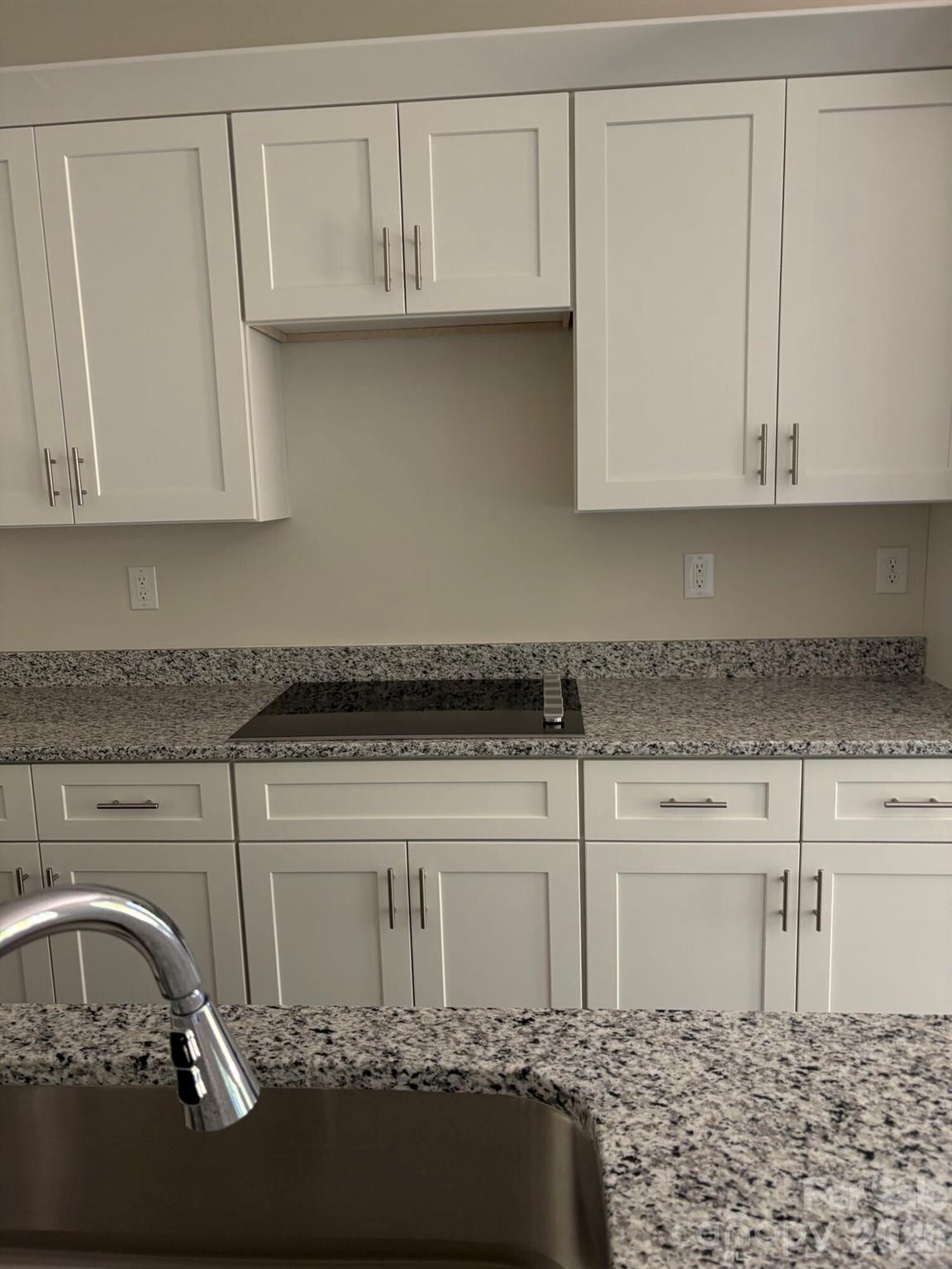 250 Ashley Acres Road Statesville, NC 28677 - Photo 10 of 21 a kitchen with a stove and white cabinets