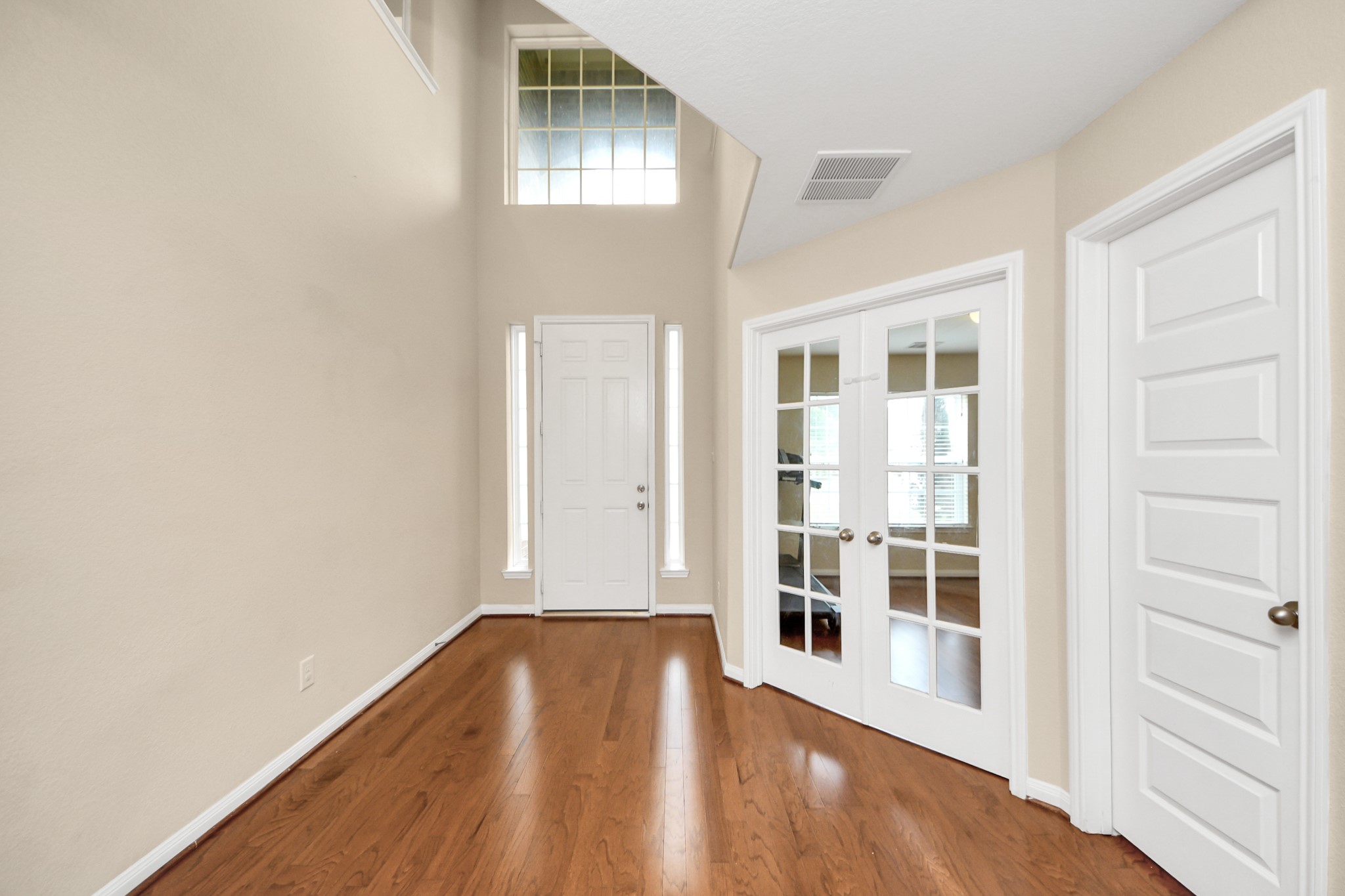 15210 Paxton Landing Lane Cypress, TX 77433 - Photo 12 of 50 an empty room with wooden floor and windows