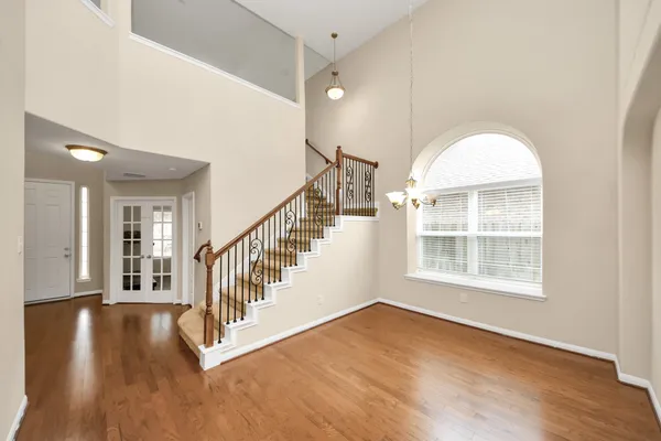 a view of an entryway with wooden floor and door