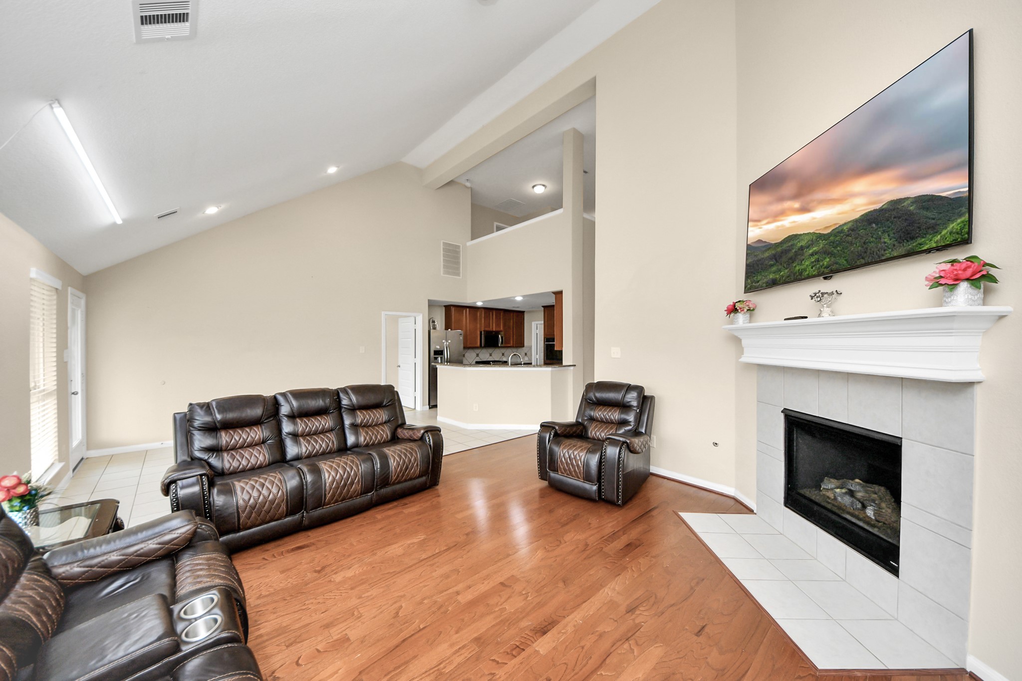 15210 Paxton Landing Lane Cypress, TX 77433 - Photo 16 of 50 a living room with furniture a flat screen tv and a fireplace