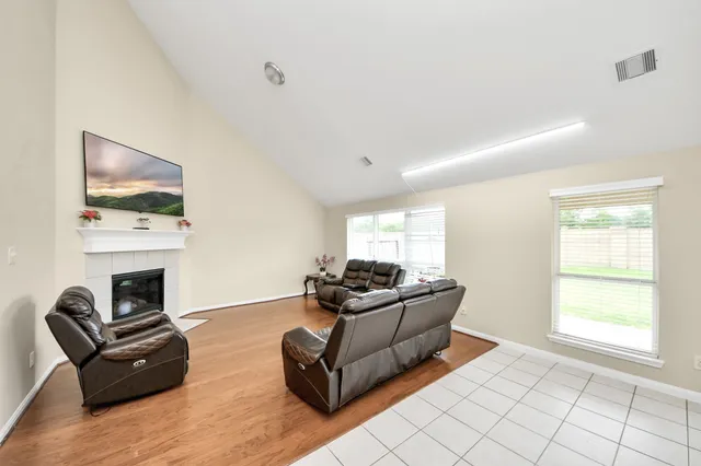 a living room with furniture fireplace and window