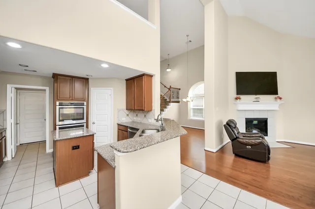 a kitchen with a refrigerator and a stove top oven