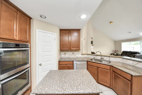 a kitchen with a sink stove and refrigerator