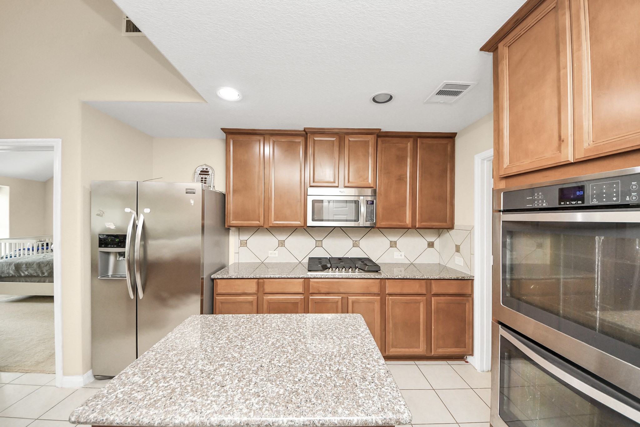 15210 Paxton Landing Lane Cypress, TX 77433 - Photo 25 of 50 a kitchen with stainless steel appliances granite countertop a sink stove and refrigerator