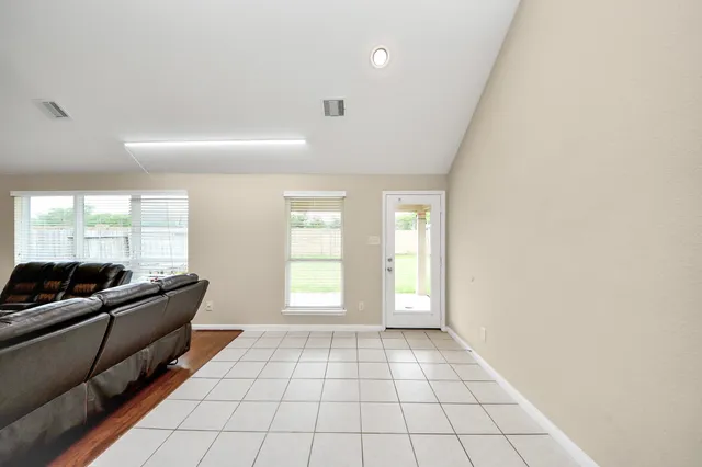 a living room with furniture and a floor to ceiling window