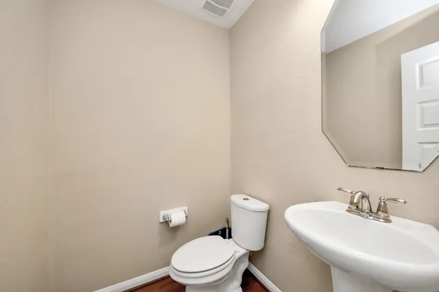 a white toilet sitting next to a bathroom sink