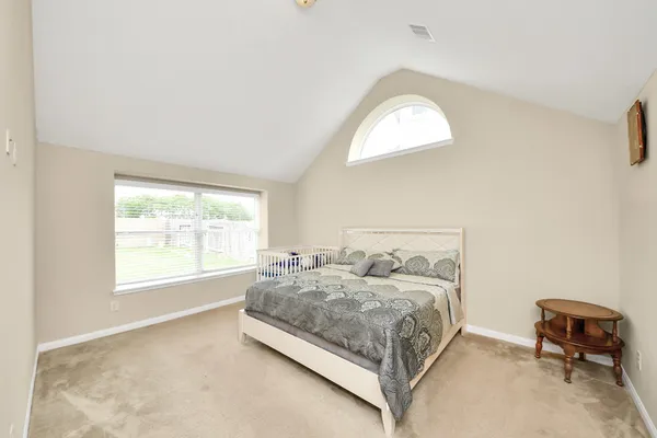 a bedroom with a bed and a chair