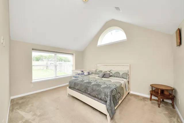 a bedroom with a bed and a chair