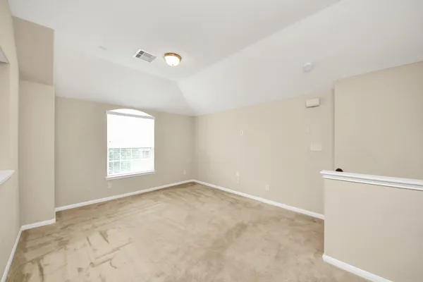 a view of an empty room with a window