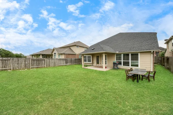 a view of a house with a backyard